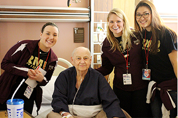 Student athletes visit with a veteran at the Oklahoma City VA Medical Center as part of last year's 2014 NAIA Champions of Character events.