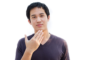 Young man using sign language
