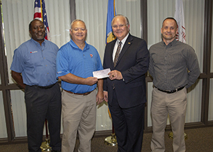 Complete Auto Care representatives Ernest Turner and Mike Sampson present $500 donation to OCCC President Jerry Steward and Professor of Automotive Technology Brad Walker