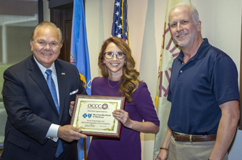 Oklahoma City Community College president Jerry Steward (left) and chair of the OCCC Board of Regents Devery Youngblood (right) thank Brooke Townsend, Blue Cross and Blue Shield of Oklahoma director of Community Affairs, for a recent grant for the OCCC Food Pantry and faculty support for the Division of Health Professions. 