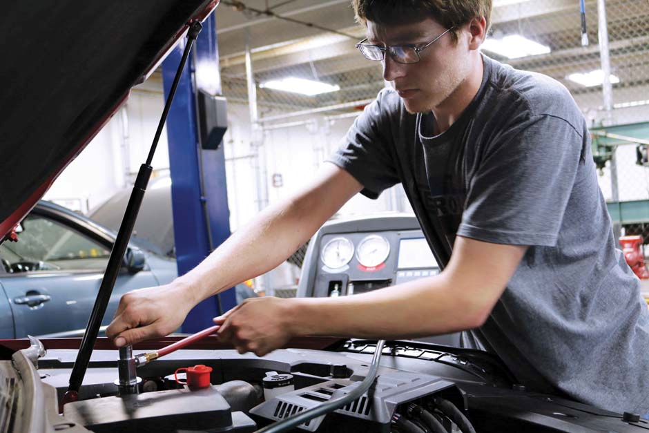 student working on a car