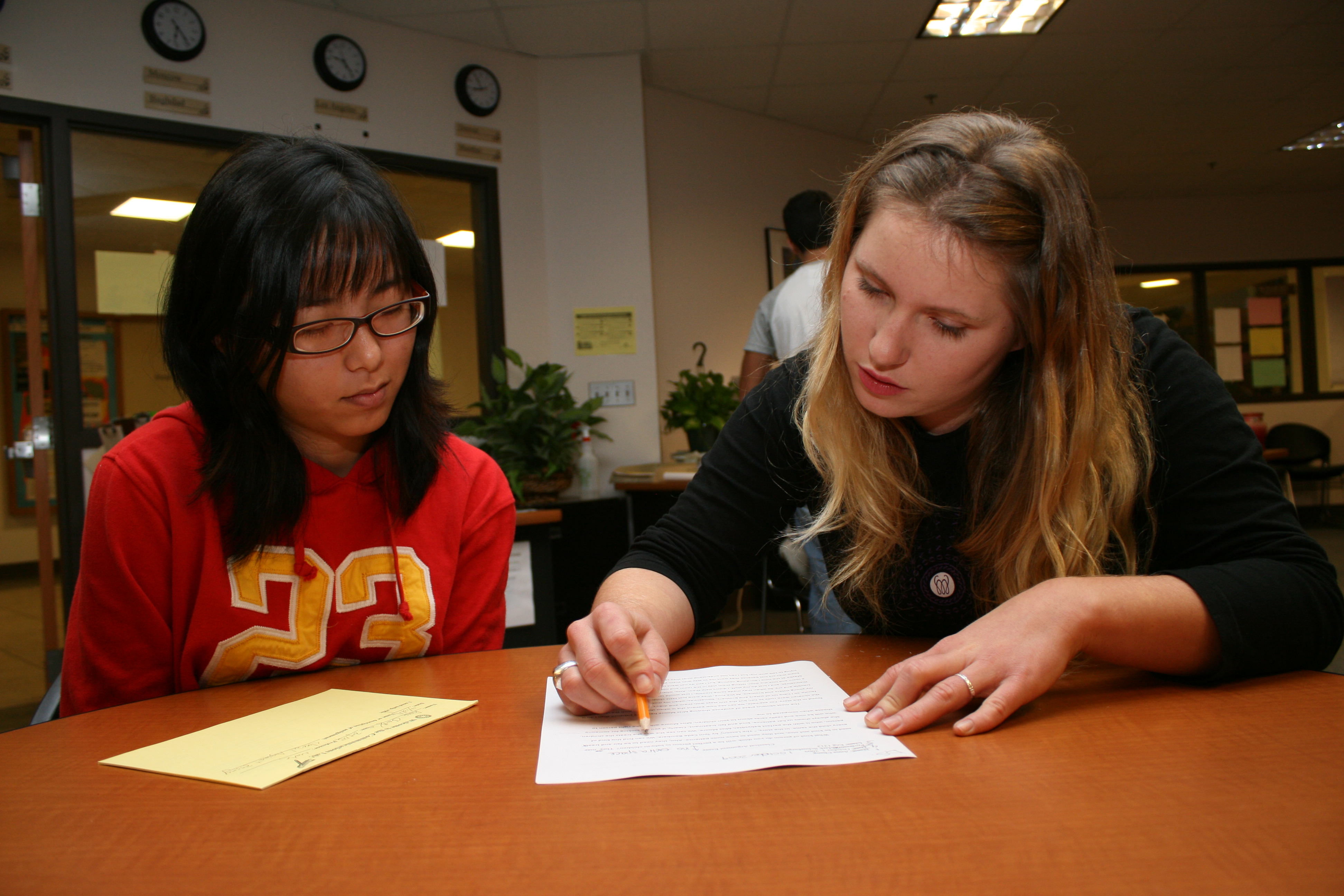 Female student getting support from a staff member.